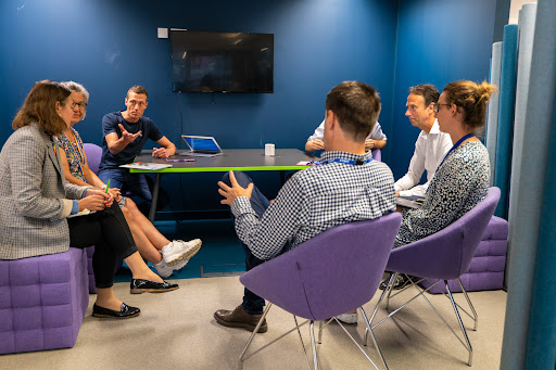 Image of people in discussion in boardroom setting