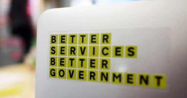 An open laptop with a sticker saying 'Better services better government'