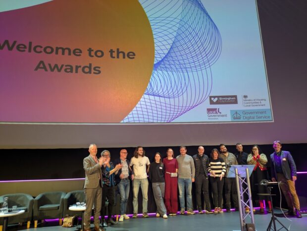 Team Match on stage with the judges after presenting their winning, data-driven prototype for intelligently matching individuals with suitable temporary accommodation. 